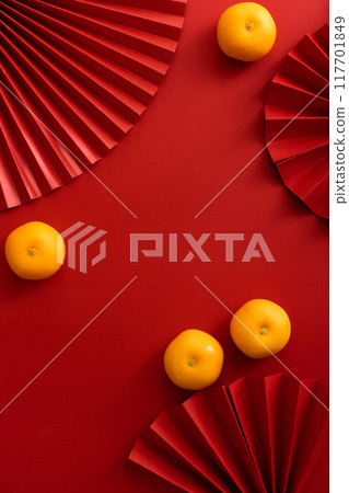 Chinese new year background design flat lay image with mandarin oranges and red paper fan 117701849