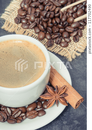 Coffee in cup and roasted dark coffee beans with anise and cinnamon 117702490