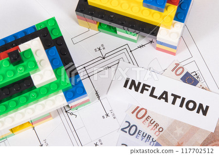Houses made of toy blocks, house plan, euro banknotes with inscription inflation Houses made of toy blocks, house plan, euro banknotes with inscription inflation 117702512