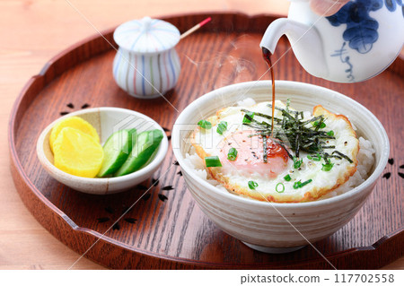 A simple fried egg bowl (rice topped with a fried egg) is fine. A simple fried egg bowl (rice topped with a fried egg) is fine. 117702558