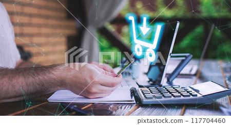 A man adds items to his cart while shopping in an international online store. E-commerce marketing offers discounts and free home delivery from any country. A man adds items to his cart while shopping in an international online store. E-commerce marketing offers discounts and free home delivery from any country. 117704460