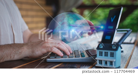 A man adds items to his cart while shopping in an international online store. E-commerce marketing offers discounts and free home delivery from any country. A man adds items to his cart while shopping in an international online store. E-commerce marketing offers discounts and free home delivery from any country. 117704469