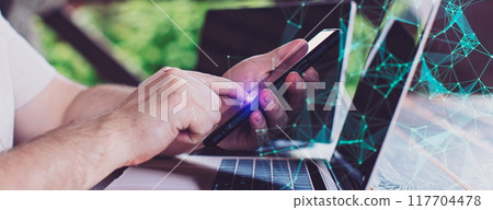 A man adds items to his cart while shopping in an international online store. E-commerce marketing offers discounts and free home delivery from any country. 117704478