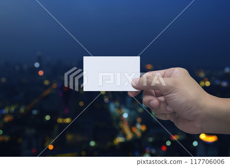 Man hand holding blank white business name card in fingers 117706006
