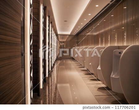 Modern public restroom with sleek white urinals and elegant lighting at night 117706201
