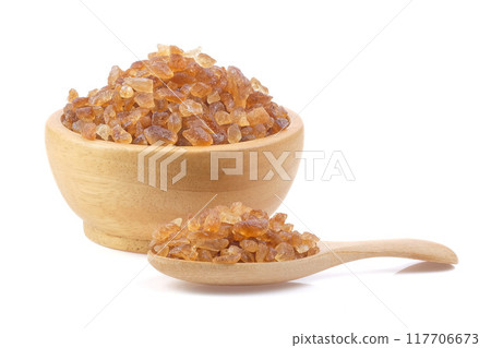 Brown rock sugars close up on white background. Brown rock sugars close up on white background. 117706673