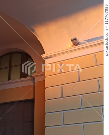 Architectural detail of the facade of a building in the evening Architectural detail of the facade of a building in the evening 117707089