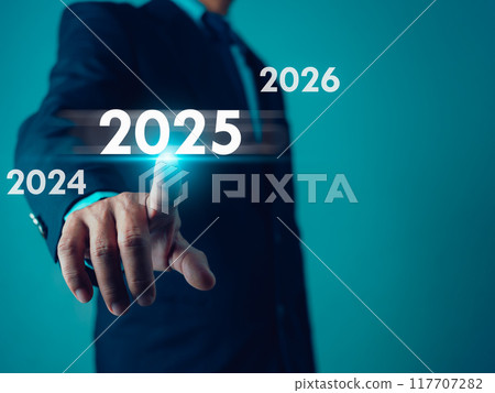 Businessman point finger at text 2025, Set goals for 2025, Implementation of business goals plan, Development to achieve goals and success, Changes in new planning, Business growth. Businessman point finger at text 2025, Set goals for 2025, Implementation of business goals plan, Development to achieve goals and success, Changes in new planning, Business growth. 117707282