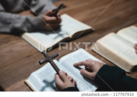 Asian men and women hands praying to god with the bible. Pray for god blessing. Religious beliefs Christian life crisis prayer to god. 117707910