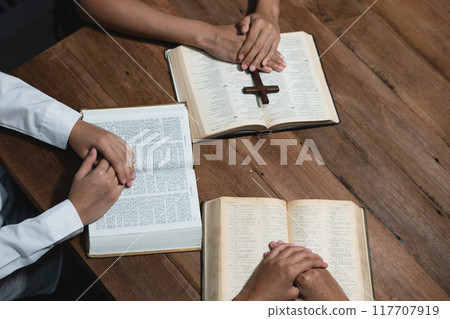 Asian men and women hands praying to god with the bible. Pray for god blessing. Religious beliefs Christian life crisis prayer to god. 117707919