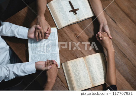 Asian men and women hands praying to god with the bible. Pray for god blessing. Religious beliefs Christian life crisis prayer to god. 117707921