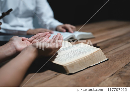 Asian men and women hands praying to god with the bible. Pray for god blessing. Religious beliefs Christian life crisis prayer to god. 117707933