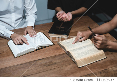 Asian men and women hands praying to god with the bible. Pray for god blessing. Religious beliefs Christian life crisis prayer to god. 117707937