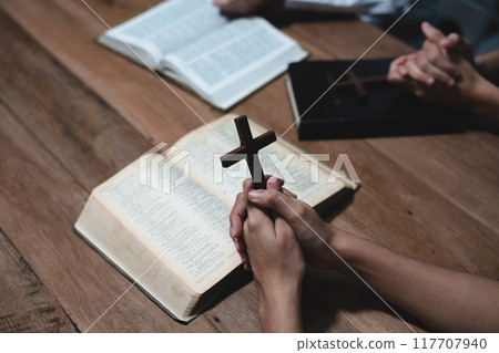 Asian men and women hands praying to god with the bible. Pray for god blessing. Religious beliefs Christian life crisis prayer to god. Asian men and women hands praying to god with the bible. Pray for god blessing. Religious beliefs Christian life crisis prayer to god. 117707940