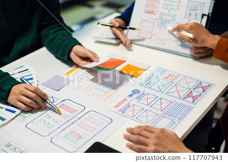 UX developer and ui designer brainstorming about mobile app interface wireframe design with customer breif and color code, User experience concept 117707943