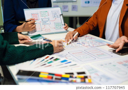 UX developer and ui designer brainstorming about mobile app interface wireframe design with customer breif and color code, User experience concept UX developer and ui designer brainstorming about mobile app interface wireframe design with customer breif and color code, User experience concept 117707945