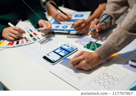 UX developer and ui designer brainstorming about mobile app interface wireframe design with customer breif and color code, User experience concept UX developer and ui designer brainstorming about mobile app interface wireframe design with customer breif and color code, User experience concept 117707967