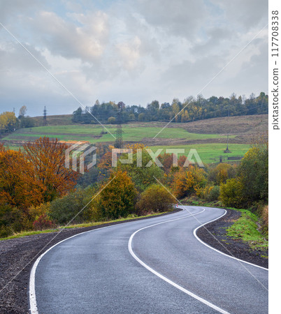 Hazy and overcast Carpathian Mountains and highway on mountain pass, Ukraine. 117708338