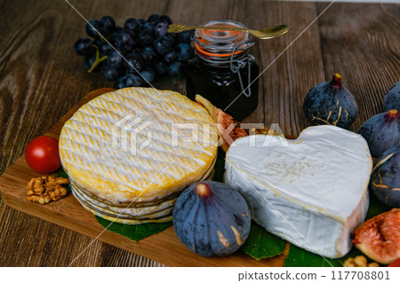 Selection of French cheeses from Normandy, AOP, Livarot, Neufchatel, Pont l'eveque, Rye bread, figs Selection of French cheeses from Normandy, AOP, Livarot, Neufchatel, Pont l'eveque, Rye bread, figs 117708801