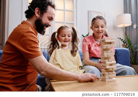 Father Engaging With Children While Playing Tabletop Game Father Engaging With Children While Playing Tabletop Game 117709019