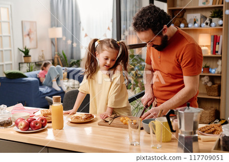 Father and Daughter Preparing Breakfast in Cozy Kitchen Father and Daughter Preparing Breakfast in Cozy Kitchen 117709051