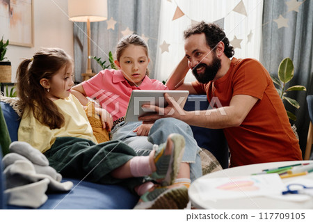 Father Engaging with Children Using Digital Tablet at Home 117709105