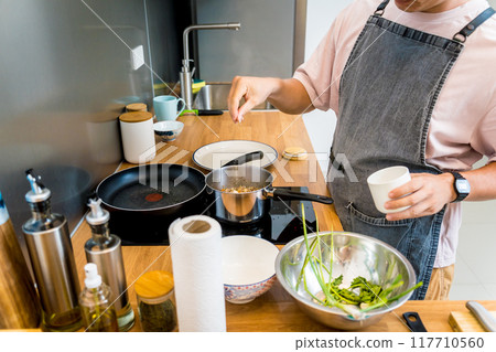 Chef at the kitchen preparing healthy quinoa bowl with avocado Chef at the kitchen preparing healthy quinoa bowl with avocado 117710560