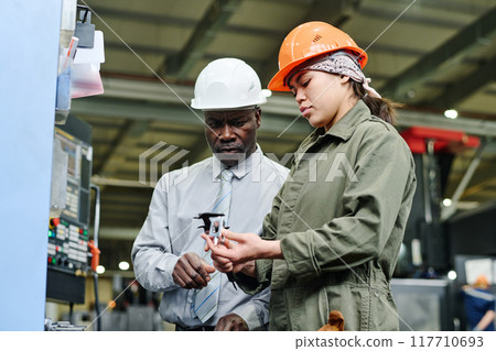 Collaborating on Machinery in Industrial Factory Setting Collaborating on Machinery in Industrial Factory Setting 117710693