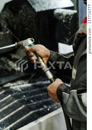 Operating Industrial Cutting Machine in Production Facility Operating Industrial Cutting Machine in Production Facility 117710777