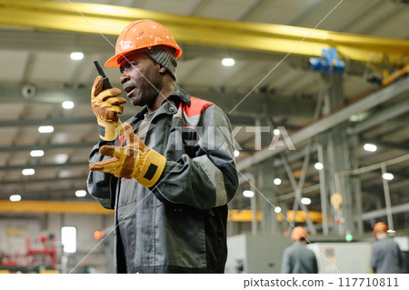 Engineer Inspecting Construction Site Using Smartphone 117710811