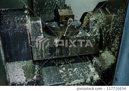 Operating CNC Milling Machine in Industrial Workshop Operating CNC Milling Machine in Industrial Workshop 117710834