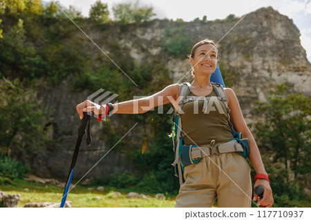 An Adventurous Hiker Exploring the Breathtaking Beauty of Nature with a Scenic Background 117710937