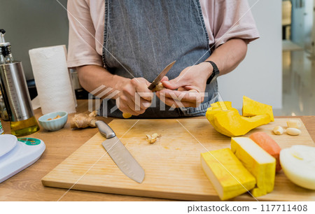 Chef at the kitchen preparing pumpkin porridge with tofu and vegetables Chef at the kitchen preparing pumpkin porridge with tofu and vegetables 117711408
