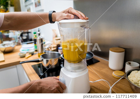 Chef at the kitchen preparing pumpkin porridge with tofu and vegetables Chef at the kitchen preparing pumpkin porridge with tofu and vegetables 117711409