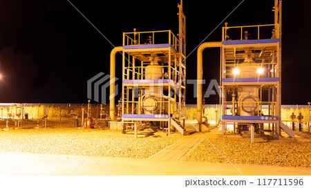 Natural gas filtration devices at a metering station at night Natural gas filtration devices at a metering station at night 117711596