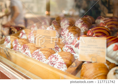 French breakfast. Close up of tray of freshly baked pastries, flavorful, warm, crispy gourmet croissants with powdered sugar, berry and cream. Bakery recipes. Concept of food, bakery, cuisine 117711742