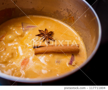 Chef at the kitchen preparing massaman curry with sweet potato and many spices 117711804