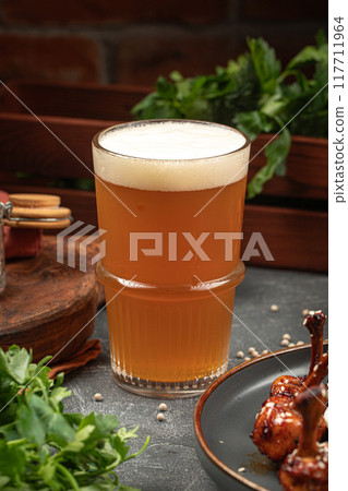 Glass of beer on grey table Glass of beer on grey table 117711964
