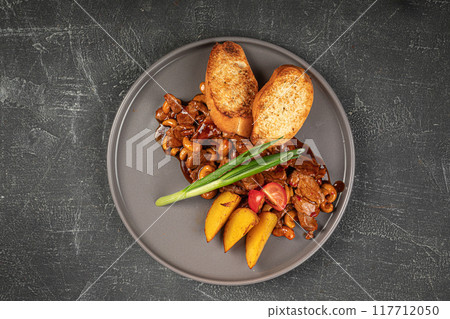 Portion of sweet and sour pork meat with potato Portion of sweet and sour pork meat with potato 117712050