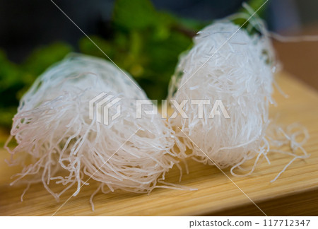 Cutting board with ingredients for preparing spicy glass noodle salad 117712347