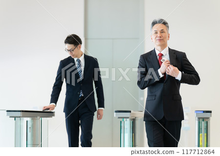Businessman holding up his ID 117712864