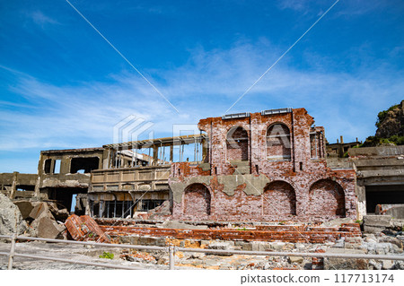 The ruins of Gunkanjima against the blue sky The ruins of Gunkanjima against the blue sky 117713174