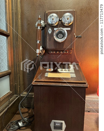 A retro wooden public telephone on display A retro wooden public telephone on display 117713479