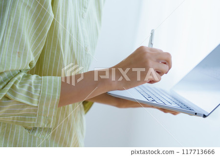 Young woman preparing to start a business in the office 117713666