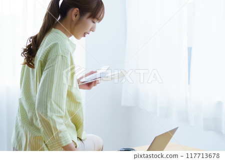 Young woman preparing to start a business in the office 117713678