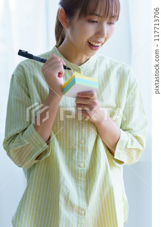 A young woman visualizing issues in the office A young woman visualizing issues in the office 117713706