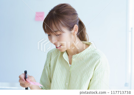 A young woman visualizing issues in the office A young woman visualizing issues in the office 117713738