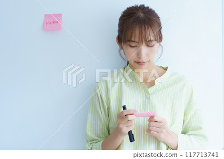 A young woman visualizing issues in the office 117713741