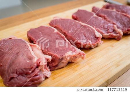 Raw fillet beef meat for steaks on the cutting board 117713819