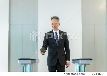 Businessman holding up his ID 117714633